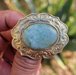 Vintage Victorian revival ornate gold brooch with light green oval stone